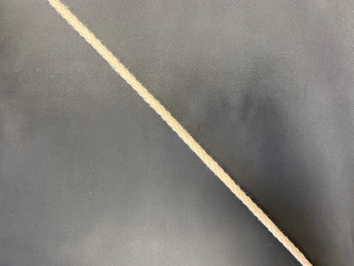 06ХК Шнур хлопковый 06мм круглый плетеный цв.сырой(в рул.100м)