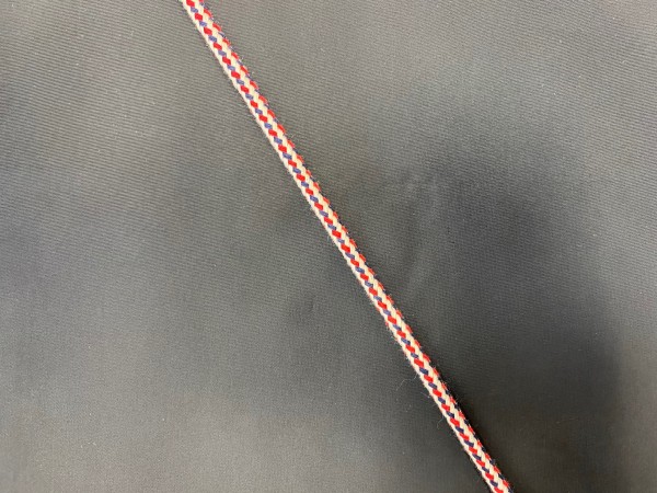 06ХК Шнур хлопковый круглый 06мм цв.красный-белый-синий(в рул.100м)